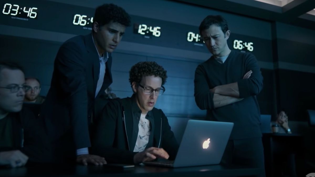 Emil, Quentin y Travis mirando la pantalla de una computadora portátil.